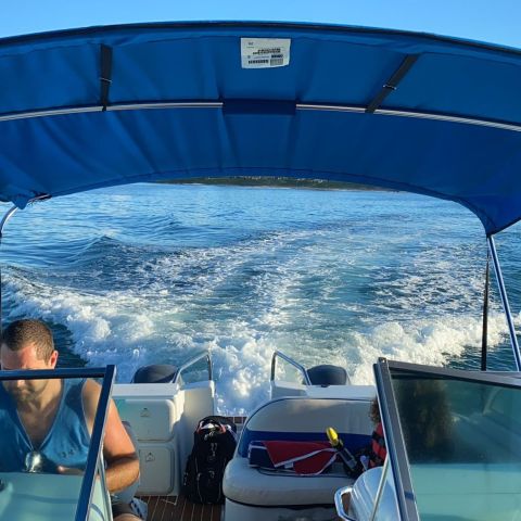 a group of people in a boat on a body of water