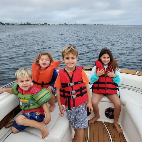 a group of people in a boat on a body of water