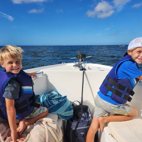a person sitting next to a body of water