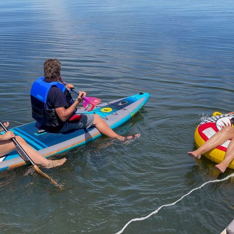 a group of people on a raft in a body of water