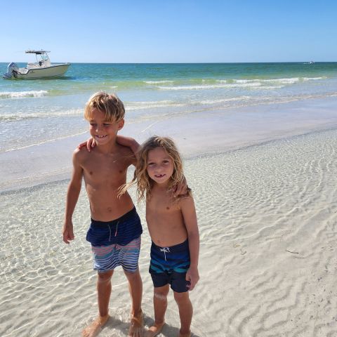 a young boy standing on a beach