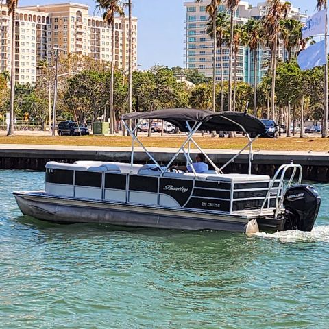 a boat on a body of water with a city in the background