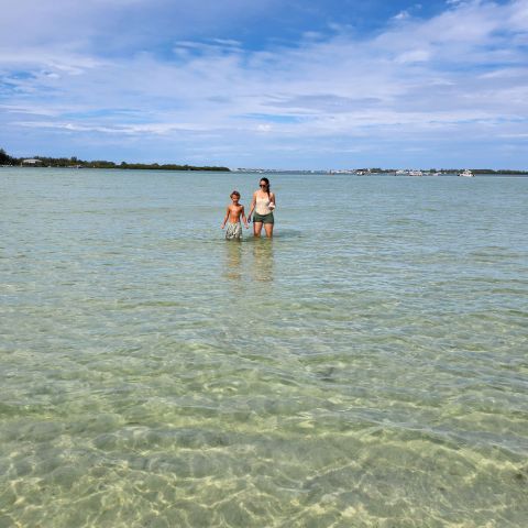 a man standing next to a body of water