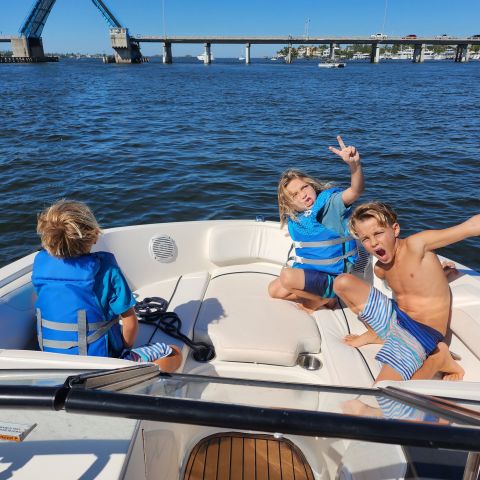 a couple of people that are sitting on a boat in the water