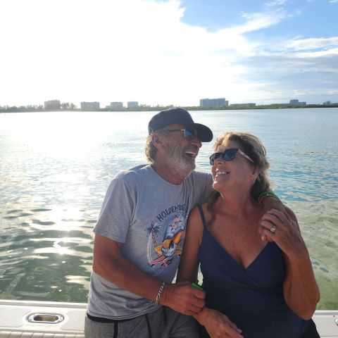 a man standing next to a body of water