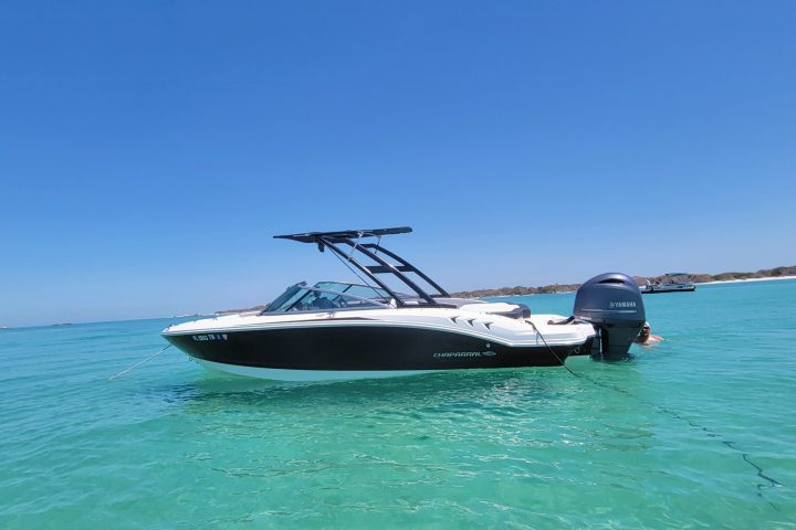 A 21-foot Chaparral Bow Rider boat rental in Sarasota, FL, floating on calm, turquoise waters, ideal for groups up to 8 people for cruising, fishing, and sandbar hopping.