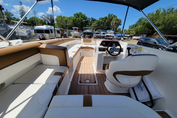 inside a Bayliner bowrider boat rental in Sarasota, FL, floating on calm, turquoise waters, ideal for family outings and versatile activities
