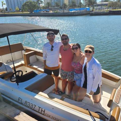 A group of people on a Bayliner bowrider boat rental in Sarasota, FL, floating on calm, turquoise waters, ideal for family outings and versatile activities