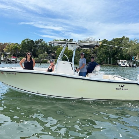 a group of people in a small boat in a body of water