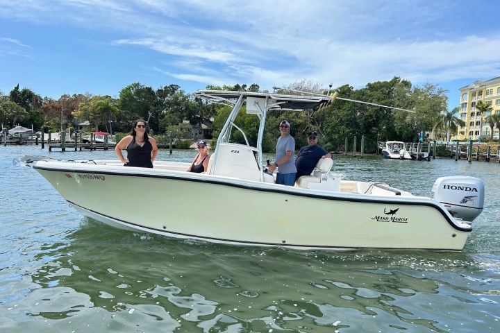 a group of people in a small boat in a body of water