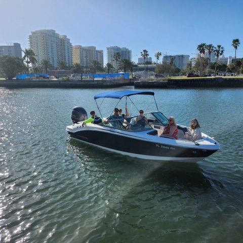a small boat in a body of water with a city in the background