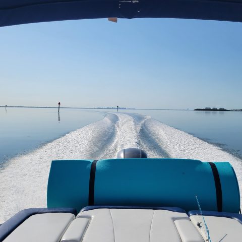 A 21-foot Chaparral Bow Rider boat rental in Sarasota, FL, riding on turquoise waters