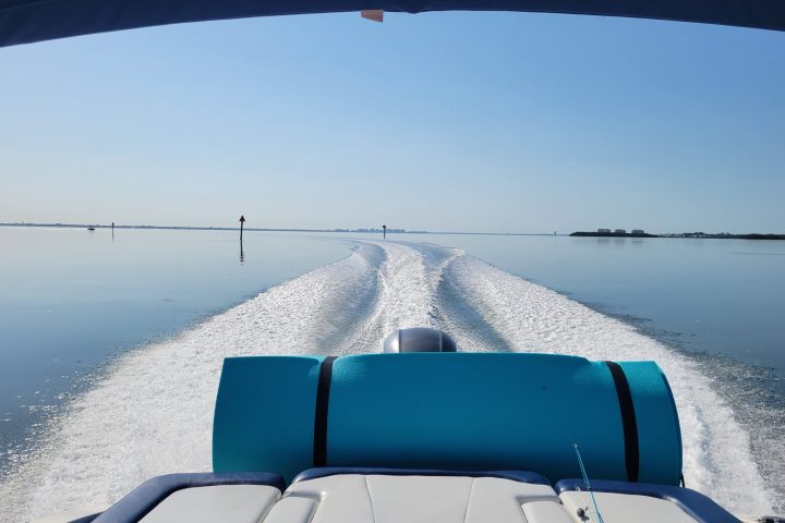A 21-foot Chaparral Bow Rider boat rental in Sarasota, FL, riding on turquoise waters