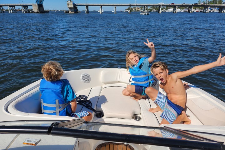 A 21-foot Chaparral Bow Rider boat rental anchored in Sarasota, FL, floating on calm, turquoise waters