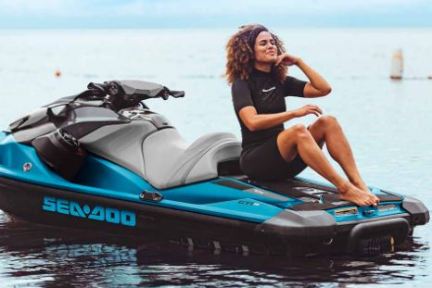 a woman sitting on a jet ski in the water