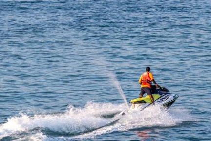 a man riding a rental jet ski in the calming waters of Sarasota