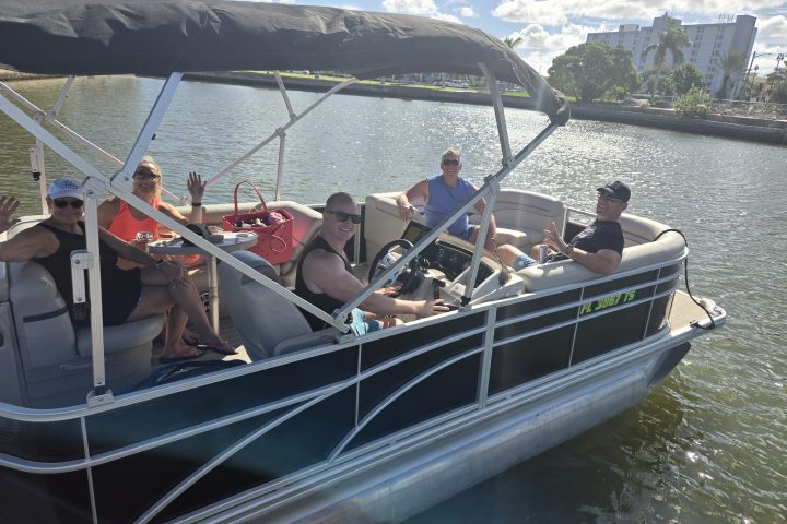 a group of people in a boat on a body of water