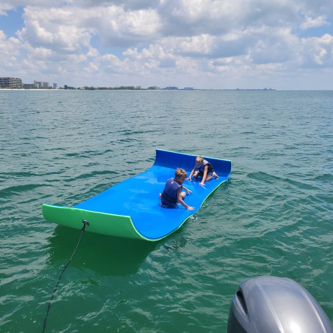 a green boat on a body of water