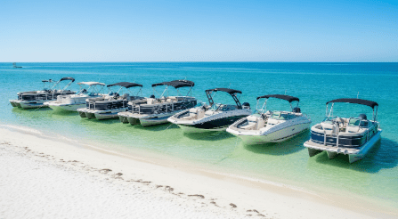 a boat sitting on top of a sandy beach next to the ocean