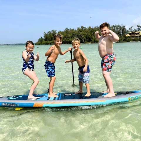 a young girl riding a wave on a surfboard in the water