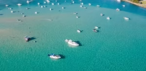 Aerial view of boats anchored at a turquoise sandbar
